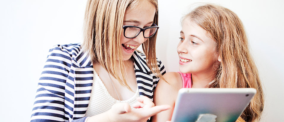 Two children viewing a mobile screen