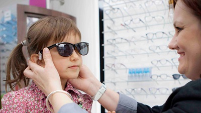 Child trying on sunglasses