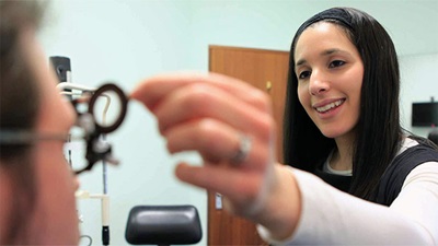 Optometrist examining patient's eyes