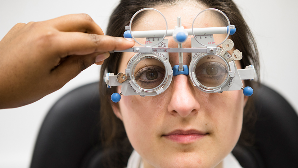 An optometrist examining a patient's eyes