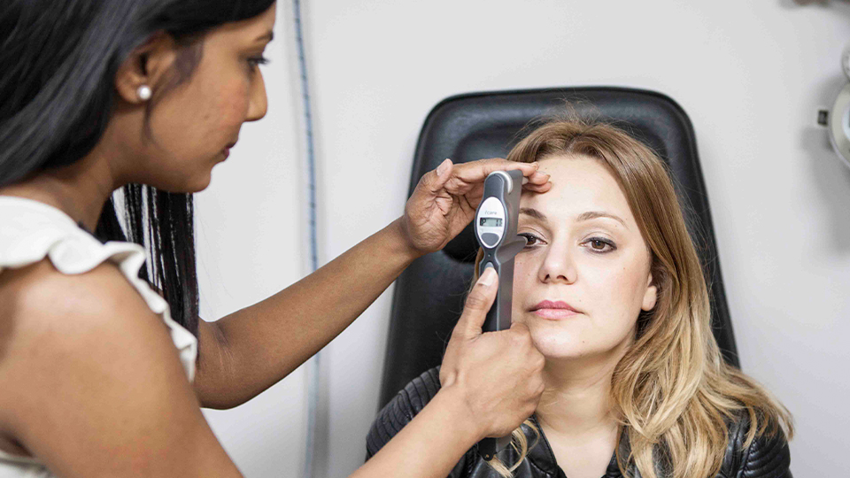 Optometrist examining patients eyes