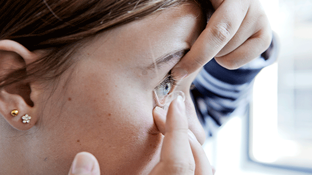 Child inserting a contact lens