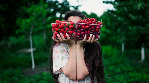 Girl holding punnets of berries