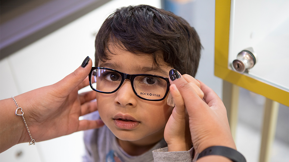 A young child wearing spectacles