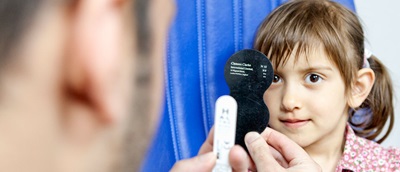 Optometrist examining a child's eyes