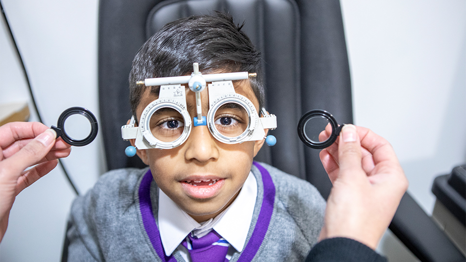 Schoolboy having an eye test