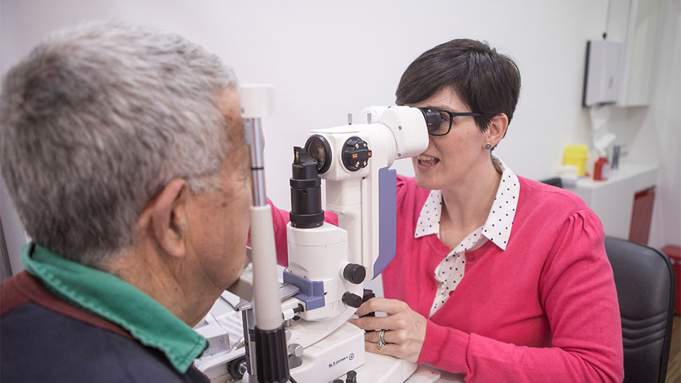Optometrist examining patients eyes