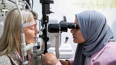 Optometrist examining patient