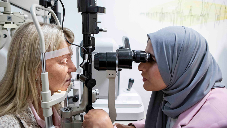 Optometrist examining patients eyes