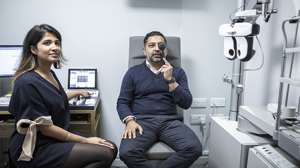 Optometrist examining patients eyes