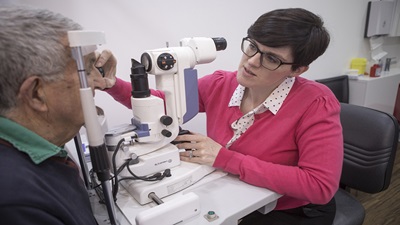 Female optometrist with elderly patient