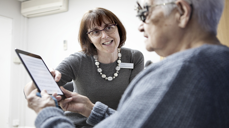 Female optometrist with elderly patient