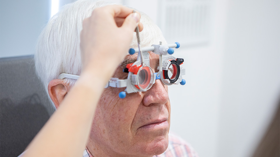 An elderly man having an eye test