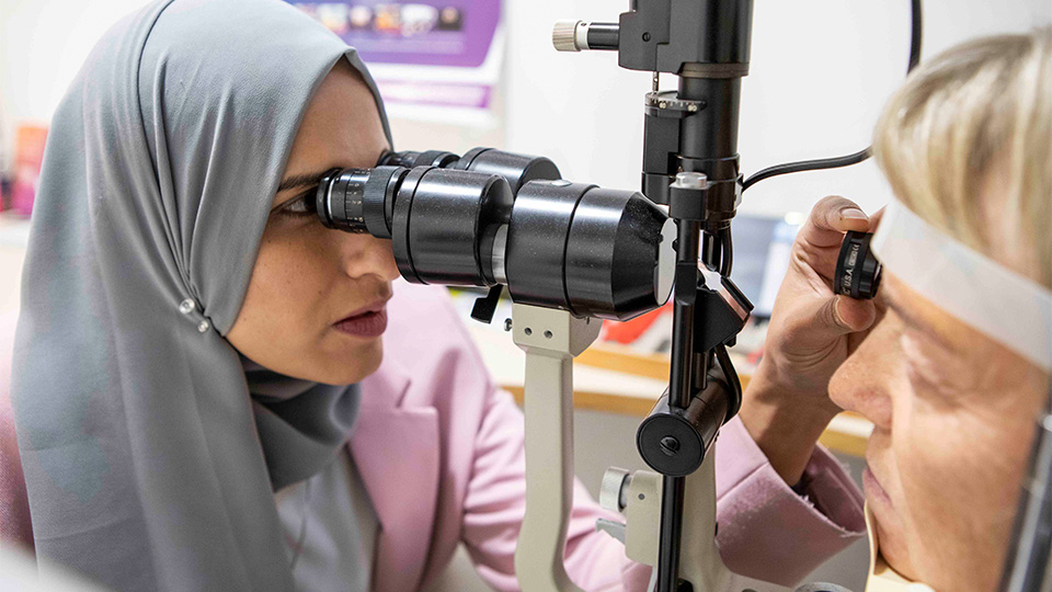 Optometrist examining patients eyes