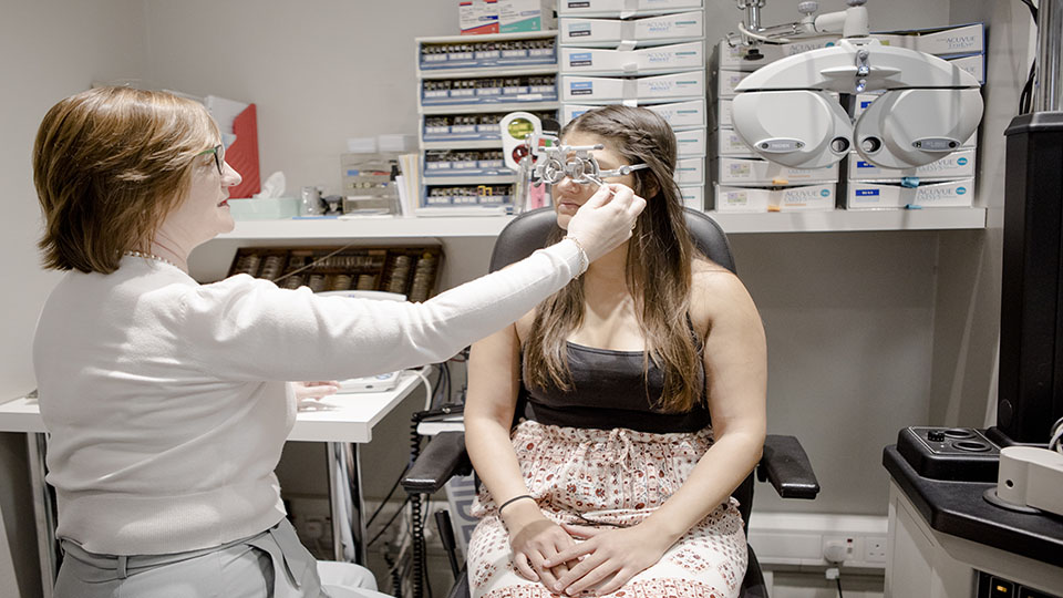 Optometrist checking patients eyes