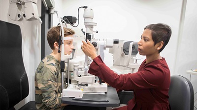 Optometrist examining child's eyes