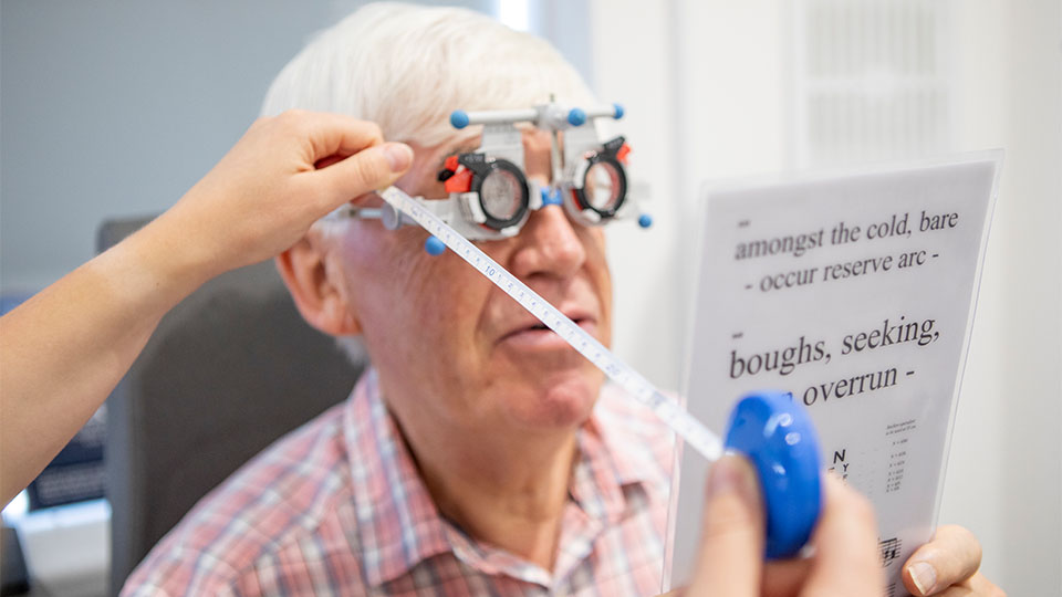 Optometrist examining patient's eyes