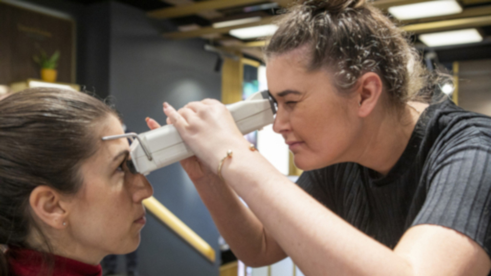 Optometrist examining patient's eyes