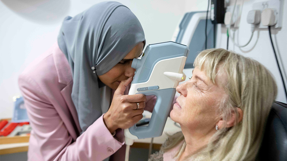 Optometrist examining patients eyes