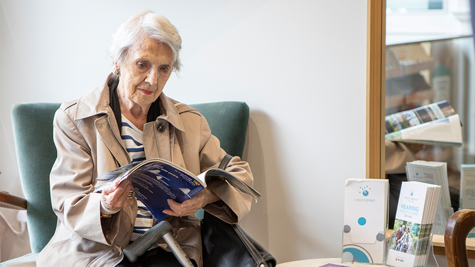 An elderly lady waiting at the opticians