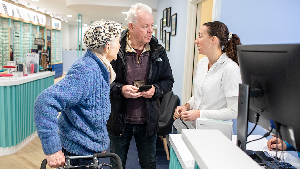 Two elderly people at practice with optometrist