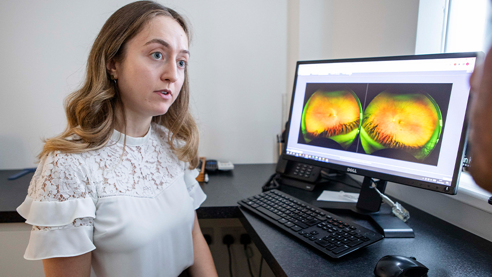 Optometrist looking at patient's OCT scan