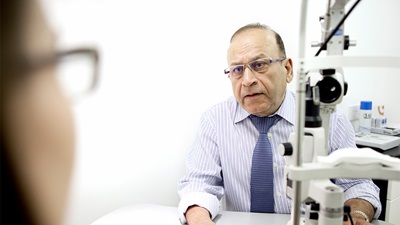 Optometrist speaking with patient