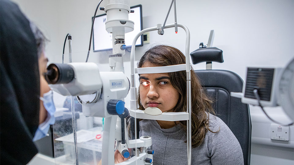 Optometrist examining patient