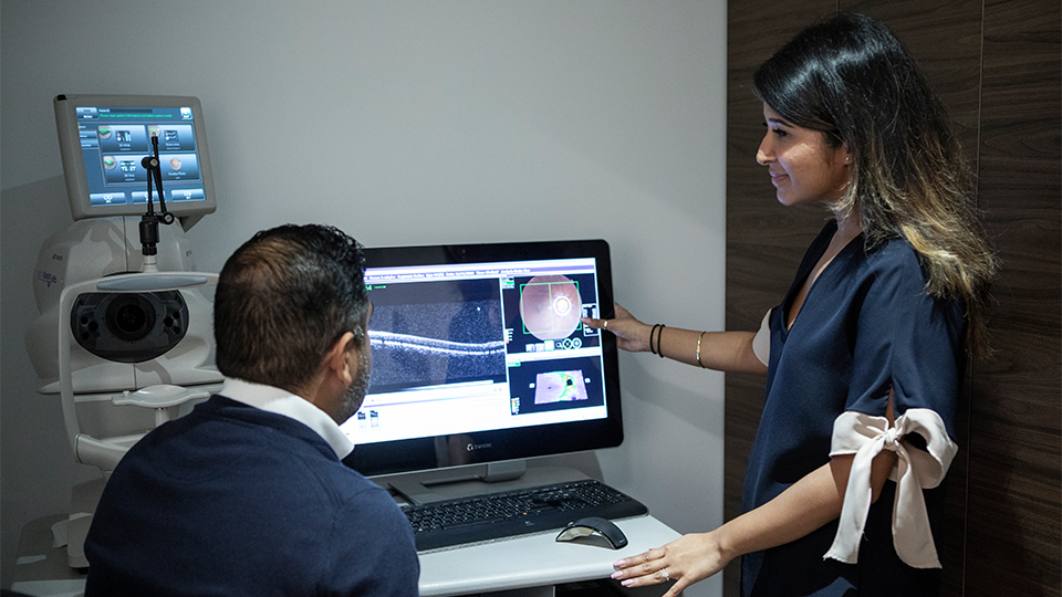 Optometrist showing patients eyes on a screen