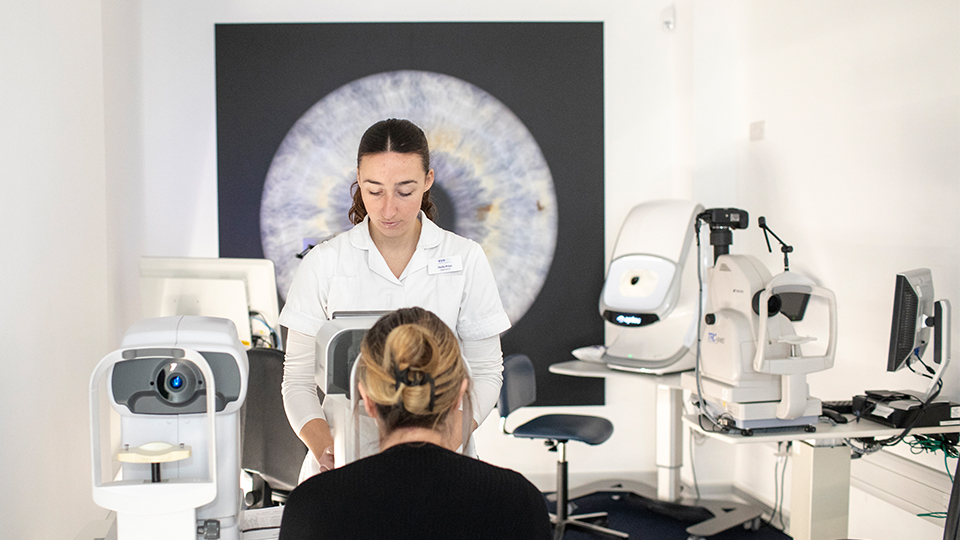 Optometrist examining patient's eyes