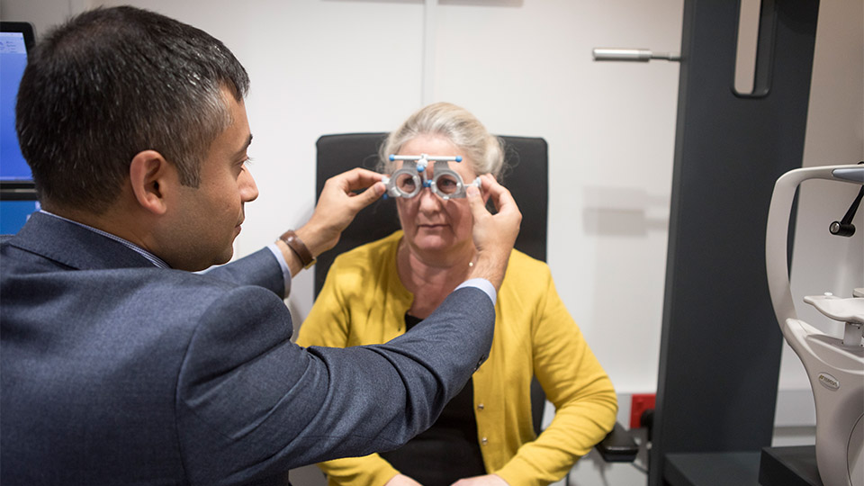 Optometrist examining patient