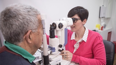 Optometrist examining patient's eyes