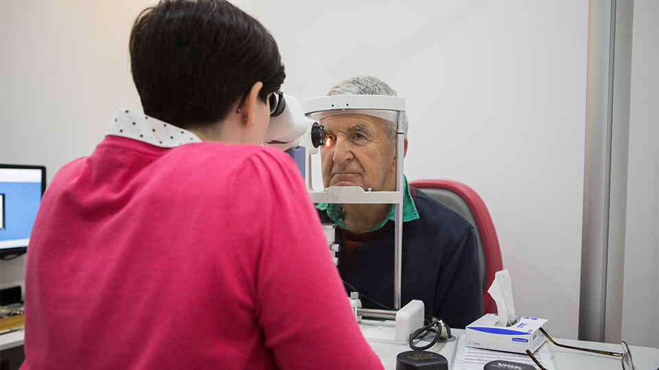 Optometrist examining patient's eyes