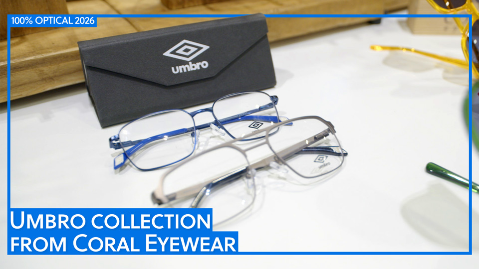 A sand-brown and royal blue pair of recycled material glasses are laid out on a display table with an Umbro-branded case behind. Text states Umbro collection from Coral Eyewear