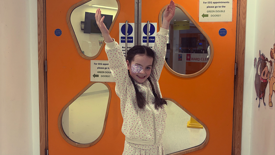 Harper poses outside of a hospital