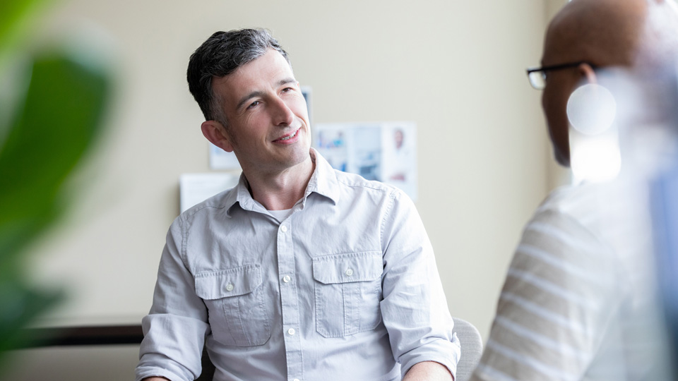Male adult siting listening to his patient during an appointment