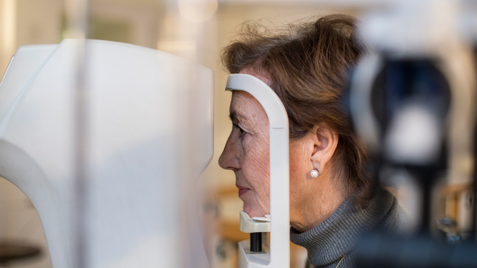 An older woman receives an eye examination