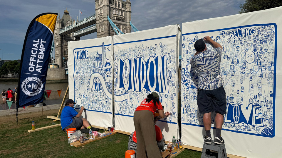 SeeAbility's Guinness World Records title mural is created by Tower Bridge on a cloudy day