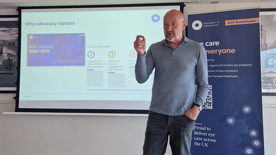 Adam Sampson stands before a screen to present for an AOP roadshow day