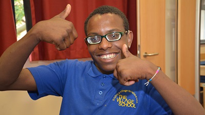 Children wearing spectacles giving the thumbs up