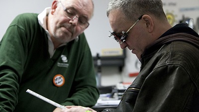 A volunteer conducts a sight test