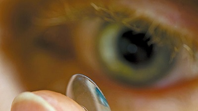 Person putting a contact lens in