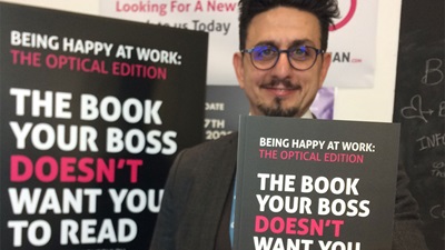 Garry Kousoulou with his book Being Happy at Work: the Optical Edition