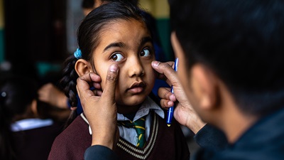 Child in Nepal having her eyes screened