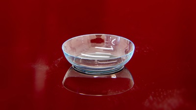 Contact lens on red background