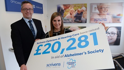 Scrivens presents the Alzheimer's Society with a cheque