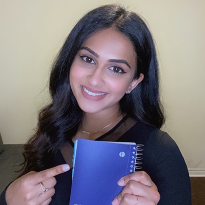 Thaksha with her notebook