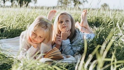 two girls and one reading
