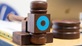 A wooden gavel decorated with the AOP logo of a blue circle rests on a table