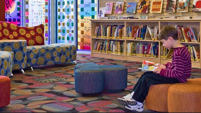 Child reading in library